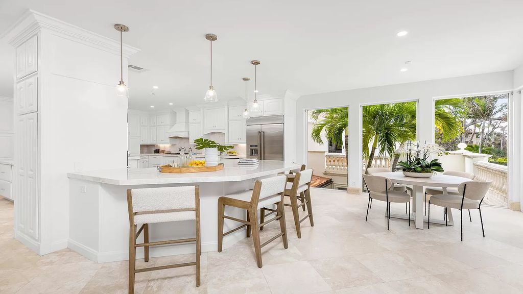 This opulent 8-bedroom estate boasts 150 feet of ocean and Intracoastal frontage, private beach house, resort-style pool, & stunning updates. Enjoy water views, private dock and manicured grounds in exclusive Manalapan.