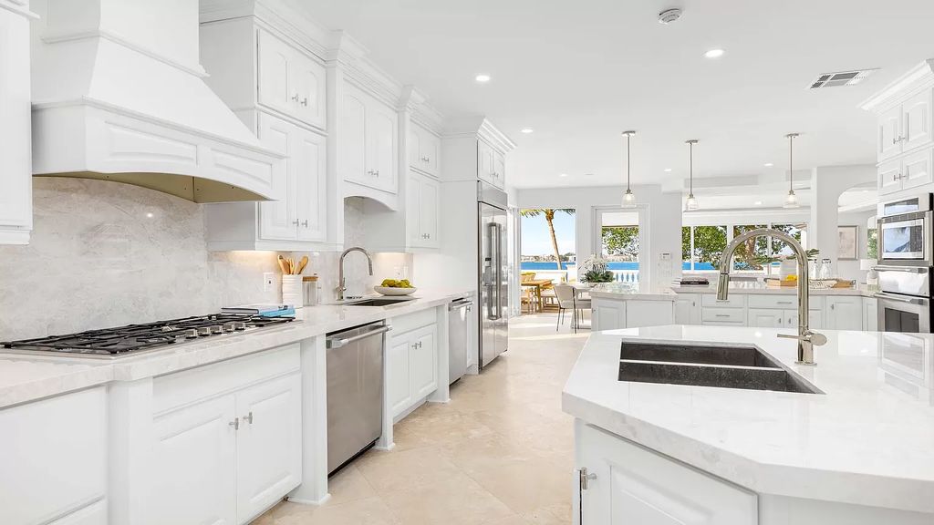 This opulent 8-bedroom estate boasts 150 feet of ocean and Intracoastal frontage, private beach house, resort-style pool, & stunning updates. Enjoy water views, private dock and manicured grounds in exclusive Manalapan.