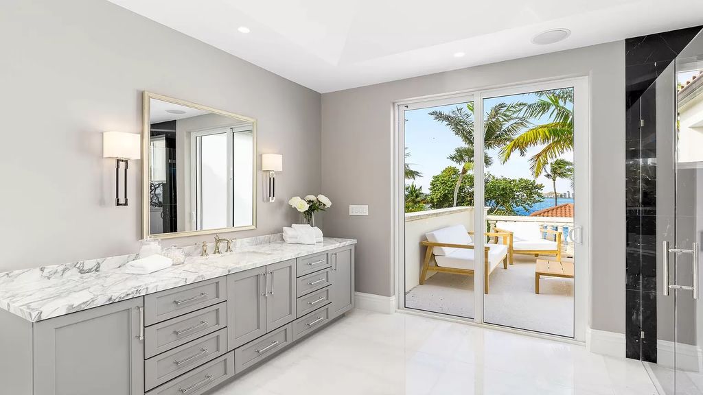 This opulent 8-bedroom estate boasts 150 feet of ocean and Intracoastal frontage, private beach house, resort-style pool, & stunning updates. Enjoy water views, private dock and manicured grounds in exclusive Manalapan.