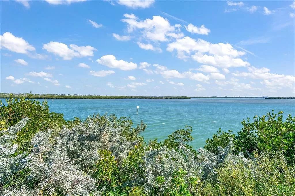 Find serenity on this pristine Florida estate. Enjoy miles of private beach, protected dockage, stunning views, and an elevated home with a unique indoor pool.