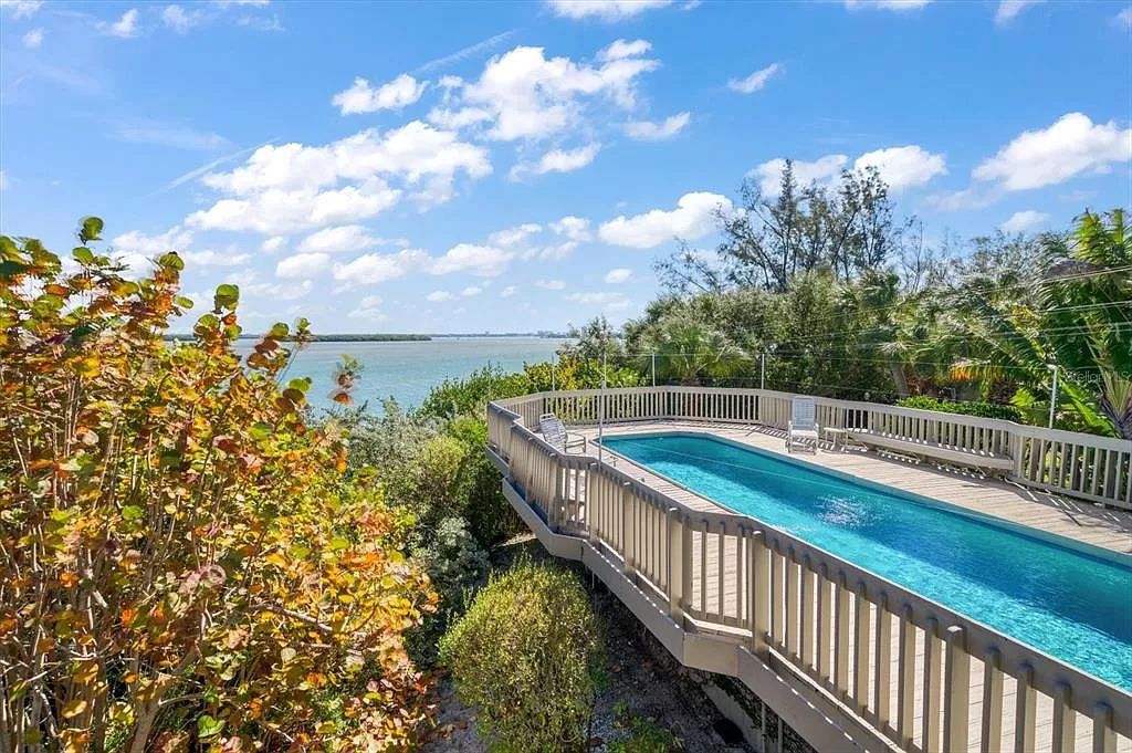 Find serenity on this pristine Florida estate. Enjoy miles of private beach, protected dockage, stunning views, and an elevated home with a unique indoor pool.