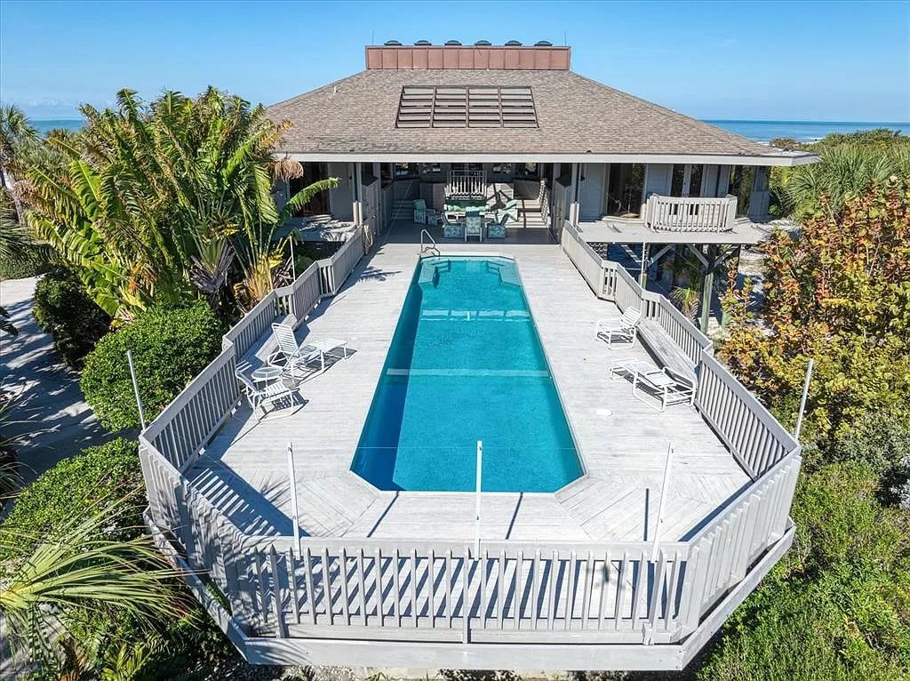 Find serenity on this pristine Florida estate. Enjoy miles of private beach, protected dockage, stunning views, and an elevated home with a unique indoor pool.