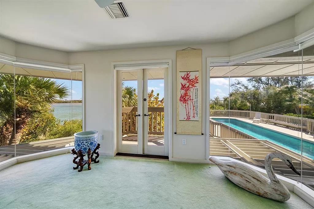 Find serenity on this pristine Florida estate. Enjoy miles of private beach, protected dockage, stunning views, and an elevated home with a unique indoor pool.