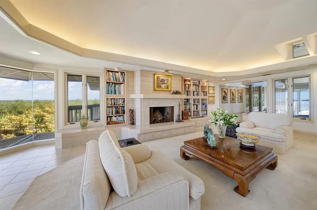 Find serenity on this pristine Florida estate. Enjoy miles of private beach, protected dockage, stunning views, and an elevated home with a unique indoor pool.