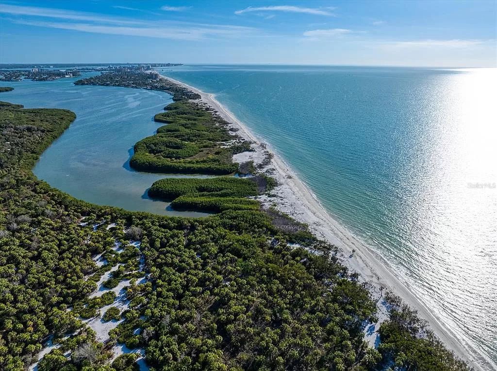 Find serenity on this pristine Florida estate. Enjoy miles of private beach, protected dockage, stunning views, and an elevated home with a unique indoor pool.