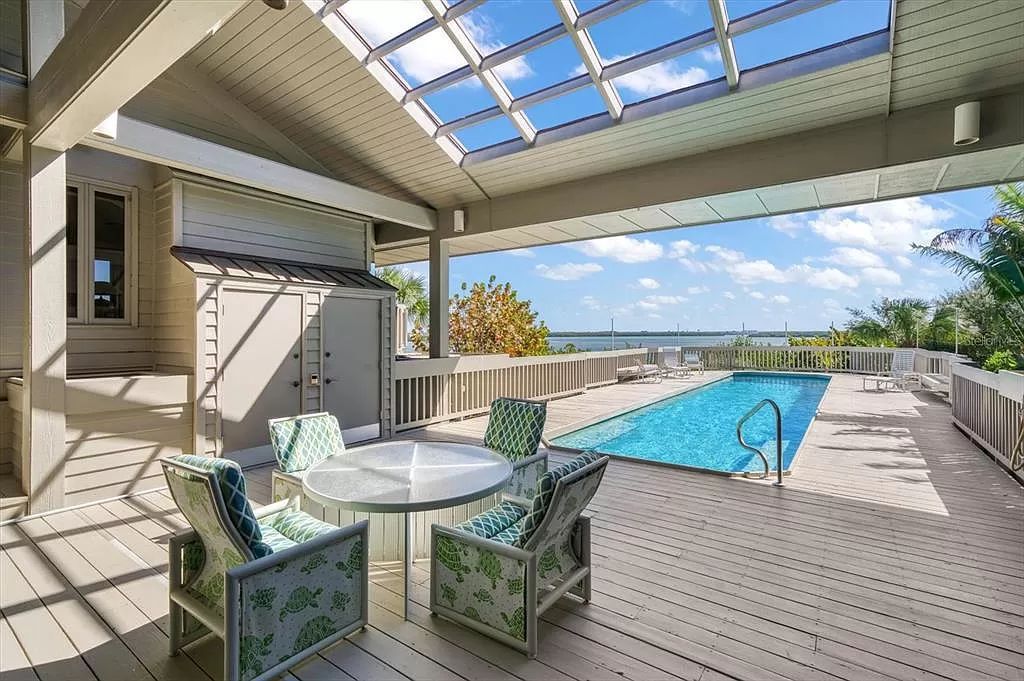 Find serenity on this pristine Florida estate. Enjoy miles of private beach, protected dockage, stunning views, and an elevated home with a unique indoor pool.