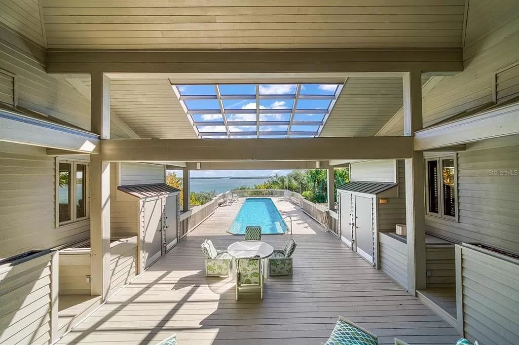 Find serenity on this pristine Florida estate. Enjoy miles of private beach, protected dockage, stunning views, and an elevated home with a unique indoor pool.