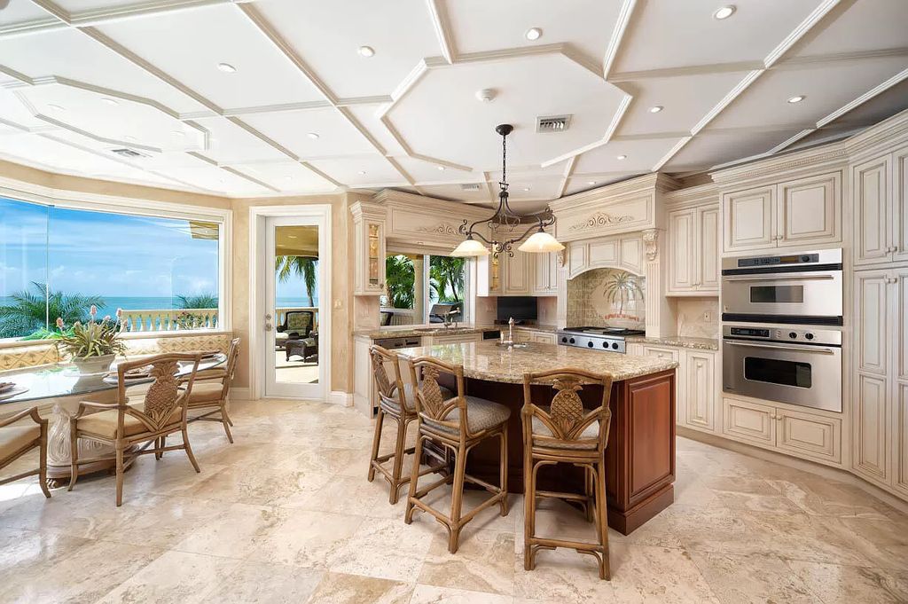 This custom estate in Key Colony Beach boasts breathtaking ocean views, a private beach, infinity pool, home theater, elevator and 4-car garage. Included: an additional lot with a 62' dock! Don't miss this rare find!