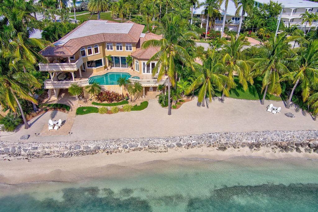 This custom estate in Key Colony Beach boasts breathtaking ocean views, a private beach, infinity pool, home theater, elevator and 4-car garage. Included: an additional lot with a 62' dock! Don't miss this rare find!