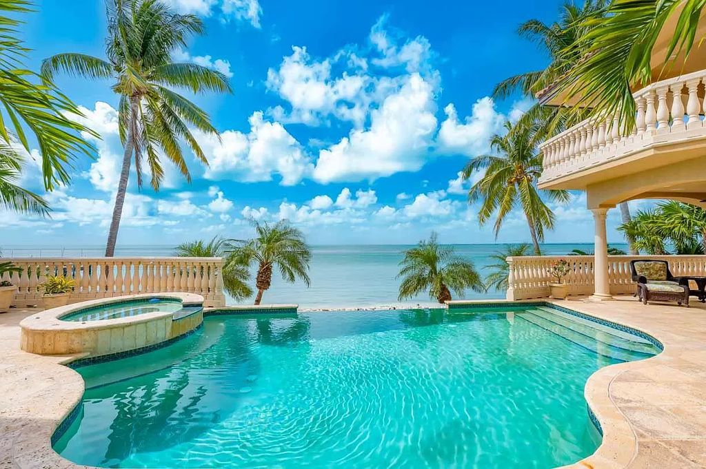 This custom estate in Key Colony Beach boasts breathtaking ocean views, a private beach, infinity pool, home theater, elevator and 4-car garage. Included: an additional lot with a 62' dock! Don't miss this rare find!