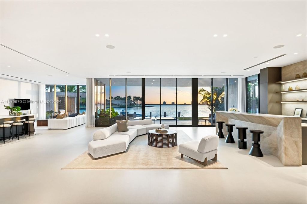 Brand-new Bay Harbor Islands masterpiece with 80 feet waterfront, sunsets, pool, spa and gourmet kitchen. Designed for entertaining by SDH Studio.