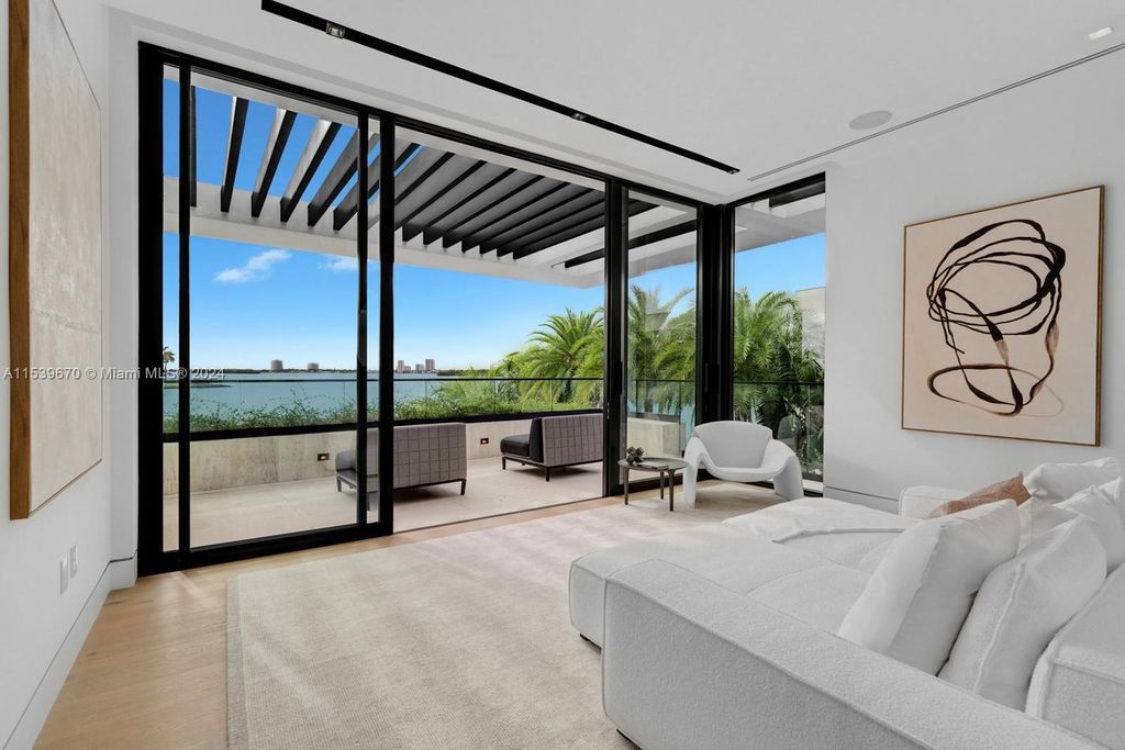 Brand-new Bay Harbor Islands masterpiece with 80 feet waterfront, sunsets, pool, spa and gourmet kitchen. Designed for entertaining by SDH Studio.