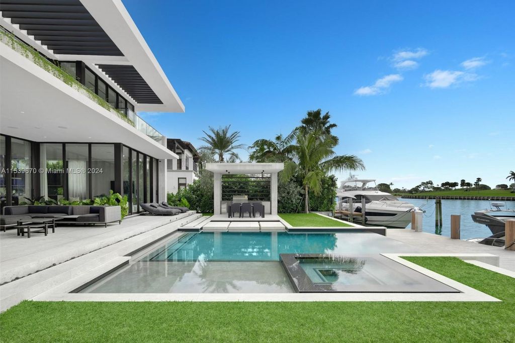 Brand-new Bay Harbor Islands masterpiece with 80 feet waterfront, sunsets, pool, spa and gourmet kitchen. Designed for entertaining by SDH Studio.