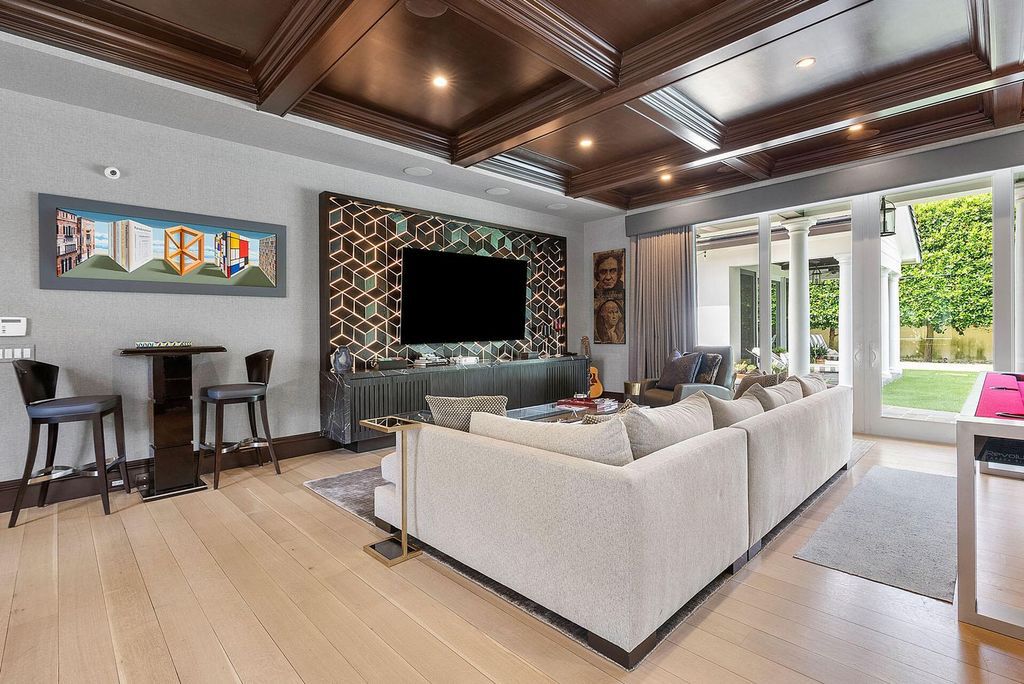 Live the epitome of luxury living in this 5-bedroom masterpiece by Tuthill Architecture in Boca Raton. Featuring a designer interior, pool, basketball court, putting green, casita, this estate offers the perfect blend of elegance and functionality.