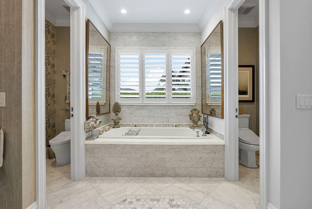 Live the epitome of luxury living in this 5-bedroom masterpiece by Tuthill Architecture in Boca Raton. Featuring a designer interior, pool, basketball court, putting green, casita, this estate offers the perfect blend of elegance and functionality.