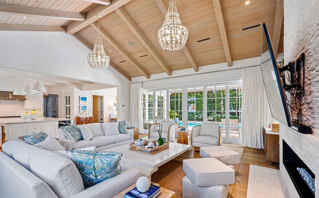 This stunning 4-bedroom estate boasts designer interiors, a sparkling pool and spa, and deeded beach club access.