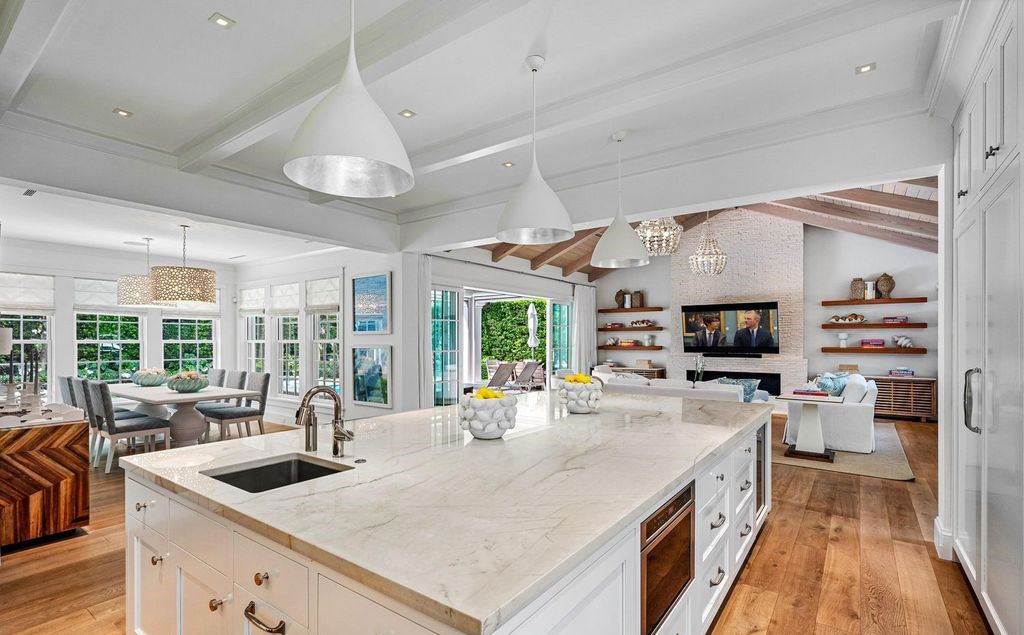 This stunning 4-bedroom estate boasts designer interiors, a sparkling pool and spa, and deeded beach club access.