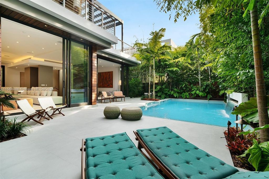 Designed by renowned architect Charles Treister, this 6-bedroom, 7-bathroom estate offers 7,146 square feet of luxurious living on a serene street in North Coconut Grove.