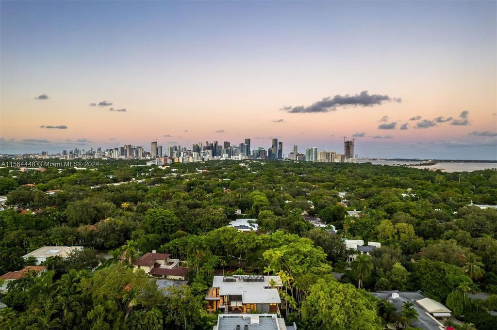 Designed by renowned architect Charles Treister, this 6-bedroom, 7-bathroom estate offers 7,146 square feet of luxurious living on a serene street in North Coconut Grove.