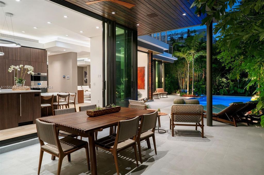 Designed by renowned architect Charles Treister, this 6-bedroom, 7-bathroom estate offers 7,146 square feet of luxurious living on a serene street in North Coconut Grove.