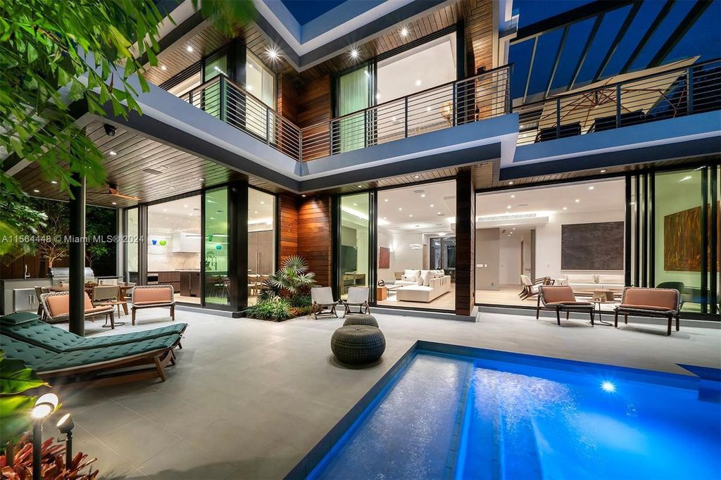 Designed by renowned architect Charles Treister, this 6-bedroom, 7-bathroom estate offers 7,146 square feet of luxurious living on a serene street in North Coconut Grove.