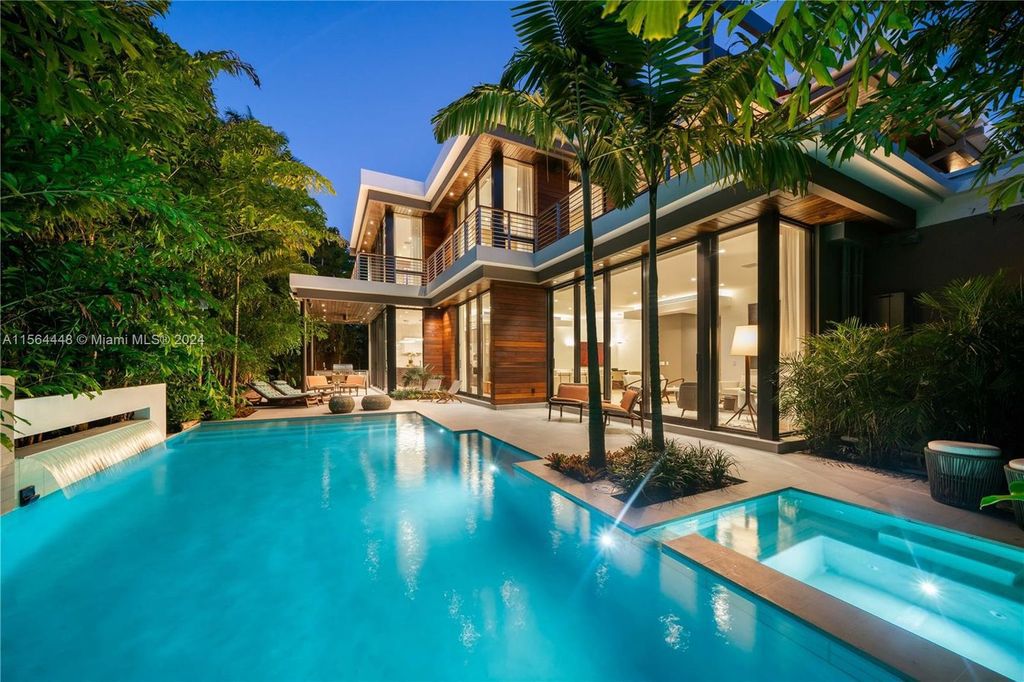 Designed by renowned architect Charles Treister, this 6-bedroom, 7-bathroom estate offers 7,146 square feet of luxurious living on a serene street in North Coconut Grove.