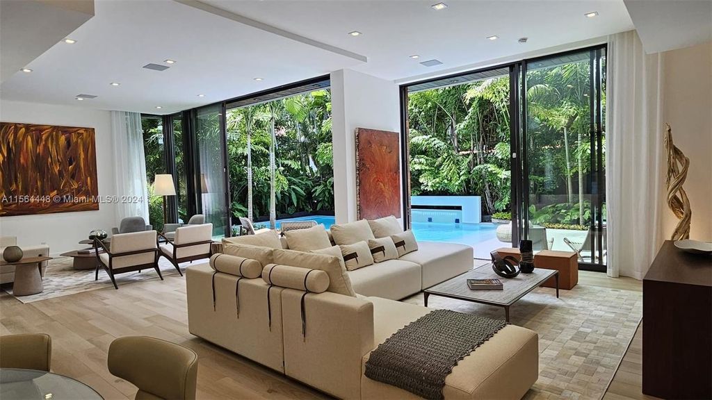 Designed by renowned architect Charles Treister, this 6-bedroom, 7-bathroom estate offers 7,146 square feet of luxurious living on a serene street in North Coconut Grove.