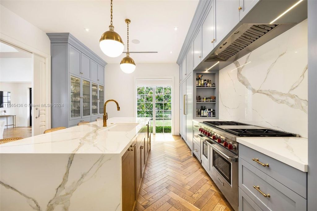 This Hamptons-inspired masterpiece boasts an expansive floor plan, gourmet kitchen with top-of-the-line appliances, and a spa-like primary suite.