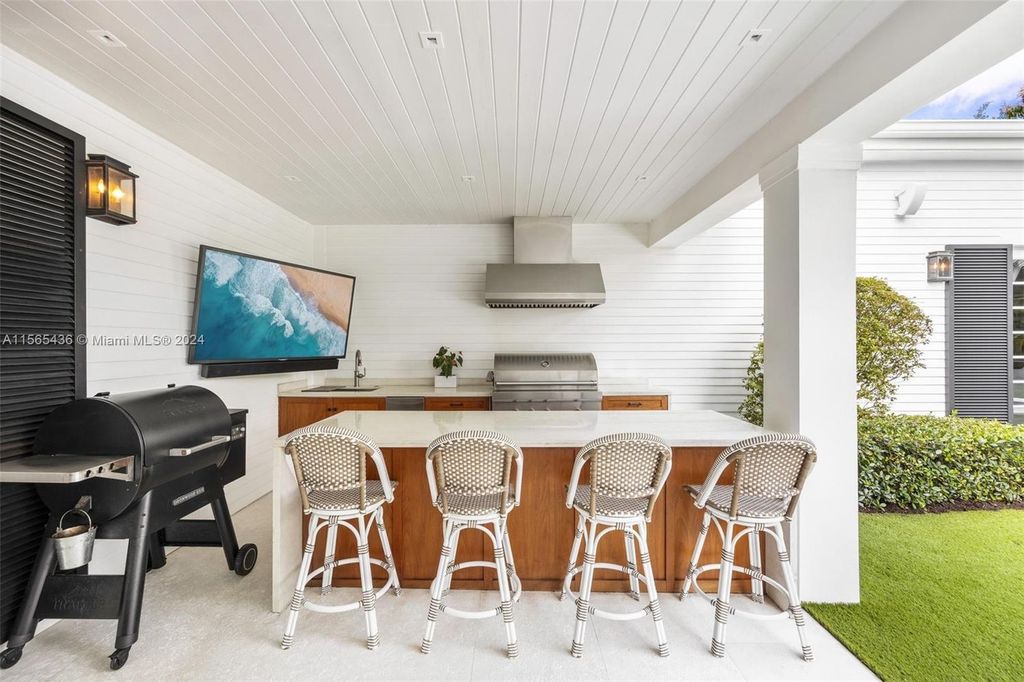 This Hamptons-inspired masterpiece boasts an expansive floor plan, gourmet kitchen with top-of-the-line appliances, and a spa-like primary suite.