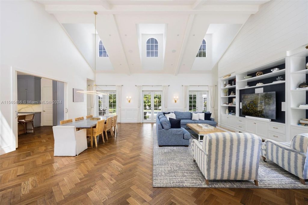 This Hamptons-inspired masterpiece boasts an expansive floor plan, gourmet kitchen with top-of-the-line appliances, and a spa-like primary suite.