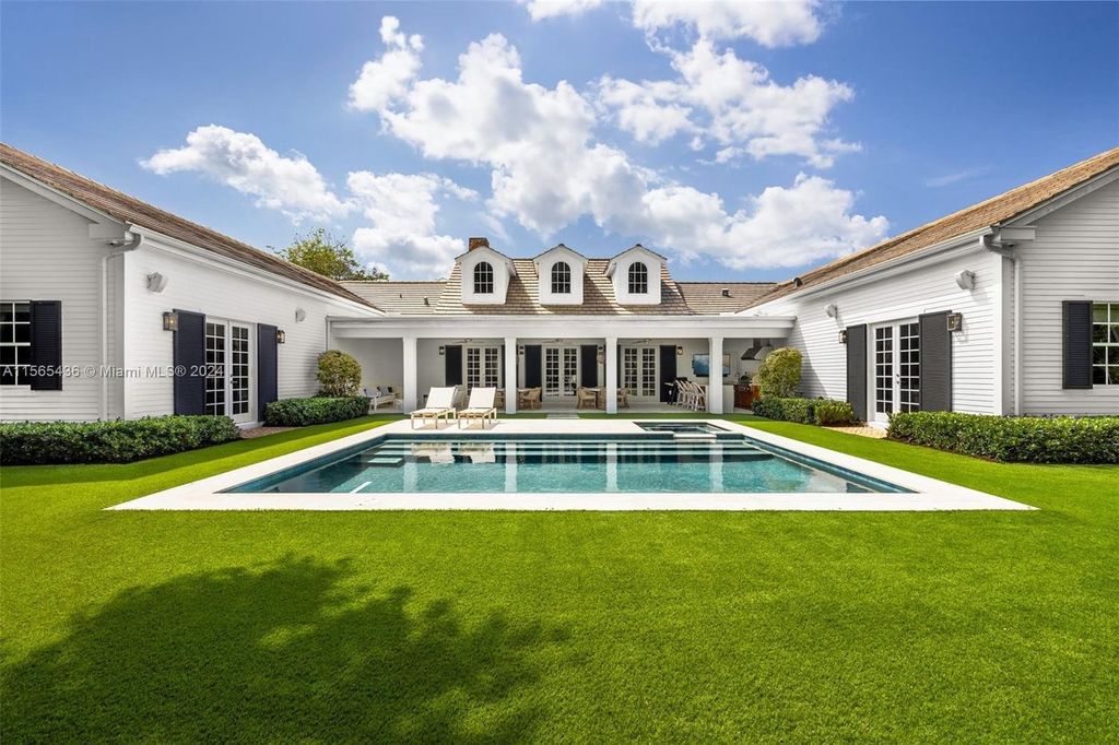 This Hamptons-inspired masterpiece boasts an expansive floor plan, gourmet kitchen with top-of-the-line appliances, and a spa-like primary suite.