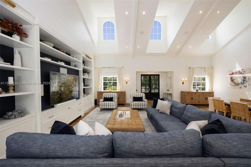 This Hamptons-inspired masterpiece boasts an expansive floor plan, gourmet kitchen with top-of-the-line appliances, and a spa-like primary suite.