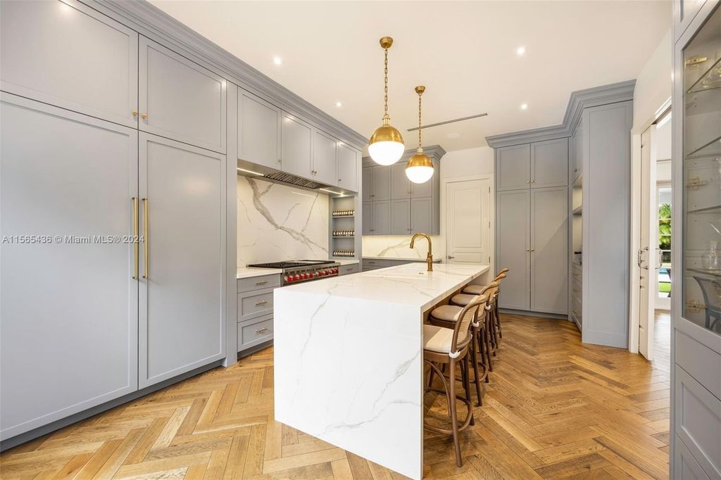 This Hamptons-inspired masterpiece boasts an expansive floor plan, gourmet kitchen with top-of-the-line appliances, and a spa-like primary suite.