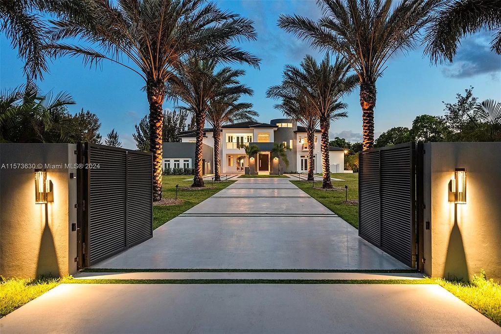 Live like royalty in this sprawling 2.25-acre Southwest Ranches estate. This 12,000+ sq ft mansion boasts resort-style amenities, a sunken entertainment area, movie theatre car showroom, and a hidden office. Experience unparalleled luxury!