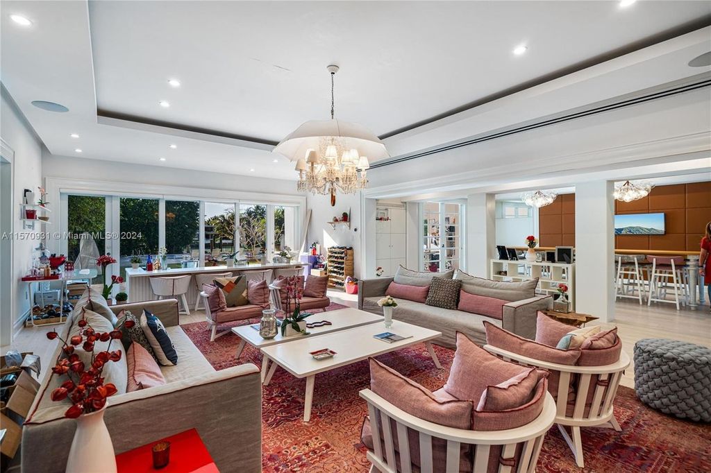 This fully renovated 7-bed, 5.5-bath masterpiece boasts stunning sunset views, a modern floor plan ideal for entertaining, and a sparkling pool with LED lighting.