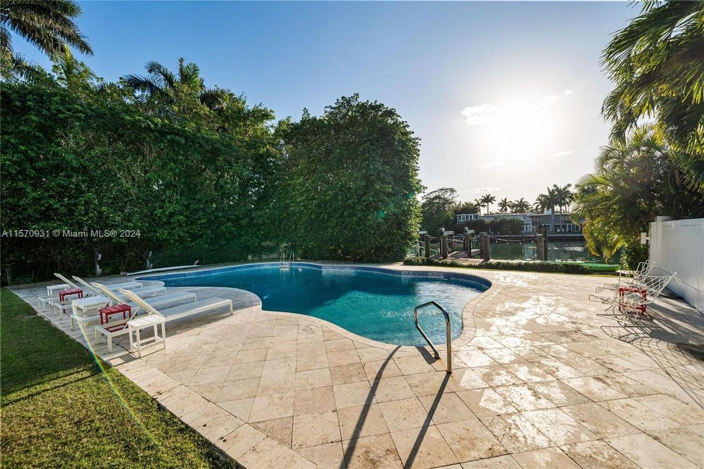 This fully renovated 7-bed, 5.5-bath masterpiece boasts stunning sunset views, a modern floor plan ideal for entertaining, and a sparkling pool with LED lighting.