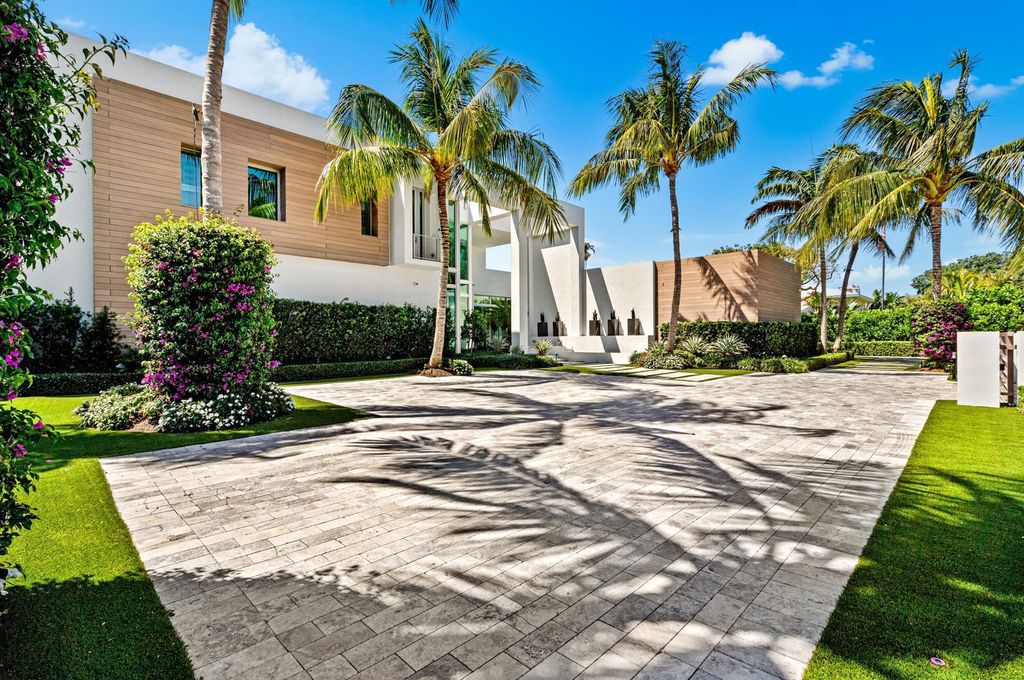 This 5-bedroom mansion in Boca Raton's Estate Section seamlessly blends indoor - outdoor living with designer finishes, resort-style pool, and lush landscaping. Designed by famed architect George Brewer, this masterpiece offers privacy and luxury in a prestigious location.