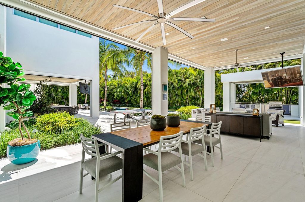 This 5-bedroom mansion in Boca Raton's Estate Section seamlessly blends indoor - outdoor living with designer finishes, resort-style pool, and lush landscaping. Designed by famed architect George Brewer, this masterpiece offers privacy and luxury in a prestigious location.