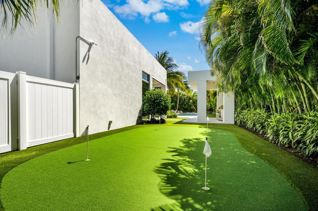 This 5-bedroom mansion in Boca Raton's Estate Section seamlessly blends indoor - outdoor living with designer finishes, resort-style pool, and lush landscaping. Designed by famed architect George Brewer, this masterpiece offers privacy and luxury in a prestigious location.