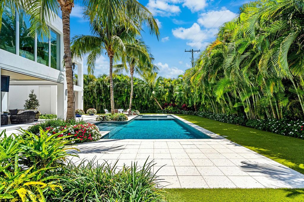 This 5-bedroom mansion in Boca Raton's Estate Section seamlessly blends indoor - outdoor living with designer finishes, resort-style pool, and lush landscaping. Designed by famed architect George Brewer, this masterpiece offers privacy and luxury in a prestigious location.