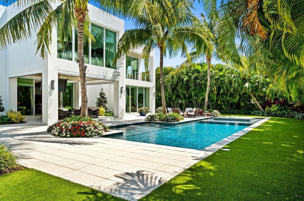 This 5-bedroom mansion in Boca Raton's Estate Section seamlessly blends indoor - outdoor living with designer finishes, resort-style pool, and lush landscaping. Designed by famed architect George Brewer, this masterpiece offers privacy and luxury in a prestigious location.