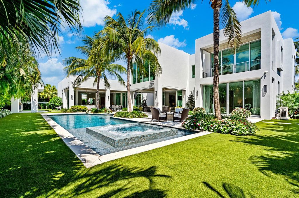 This 5-bedroom mansion in Boca Raton's Estate Section seamlessly blends indoor - outdoor living with designer finishes, resort-style pool, and lush landscaping. Designed by famed architect George Brewer, this masterpiece offers privacy and luxury in a prestigious location.