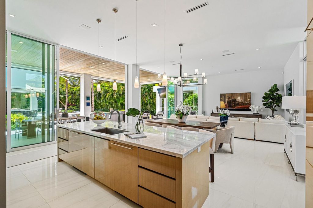 This 5-bedroom mansion in Boca Raton's Estate Section seamlessly blends indoor - outdoor living with designer finishes, resort-style pool, and lush landscaping. Designed by famed architect George Brewer, this masterpiece offers privacy and luxury in a prestigious location.