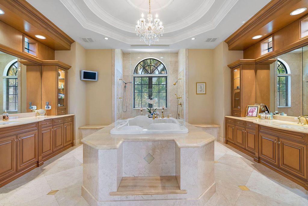 Boca Raton luxury awaits! Own a rare double-lot estate with pool, gourmet kitchen and dual master suites. Stunning golf course views in Royal Palm Yacht & Country Club.