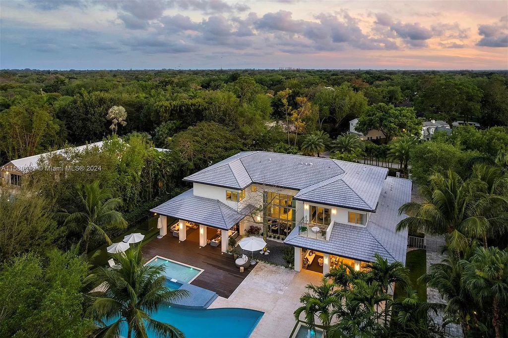 Enter a world of luxury in this exquisite 2-story gated sanctuary. Boasting a grand foyer, chef's kitchen, 4-suite bedrooms, elevator, home theater, and tropical backyard oasis with a guest house, this home offers unparalleled living.