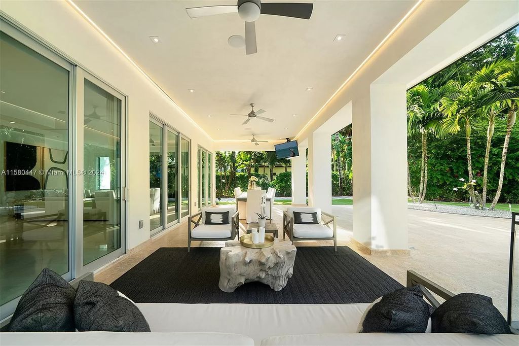 Enter a world of luxury in this exquisite 2-story gated sanctuary. Boasting a grand foyer, chef's kitchen, 4-suite bedrooms, elevator, home theater, and tropical backyard oasis with a guest house, this home offers unparalleled living.