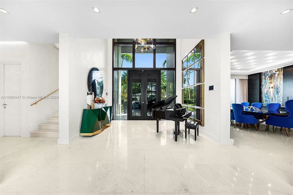 Enter a world of luxury in this exquisite 2-story gated sanctuary. Boasting a grand foyer, chef's kitchen, 4-suite bedrooms, elevator, home theater, and tropical backyard oasis with a guest house, this home offers unparalleled living.