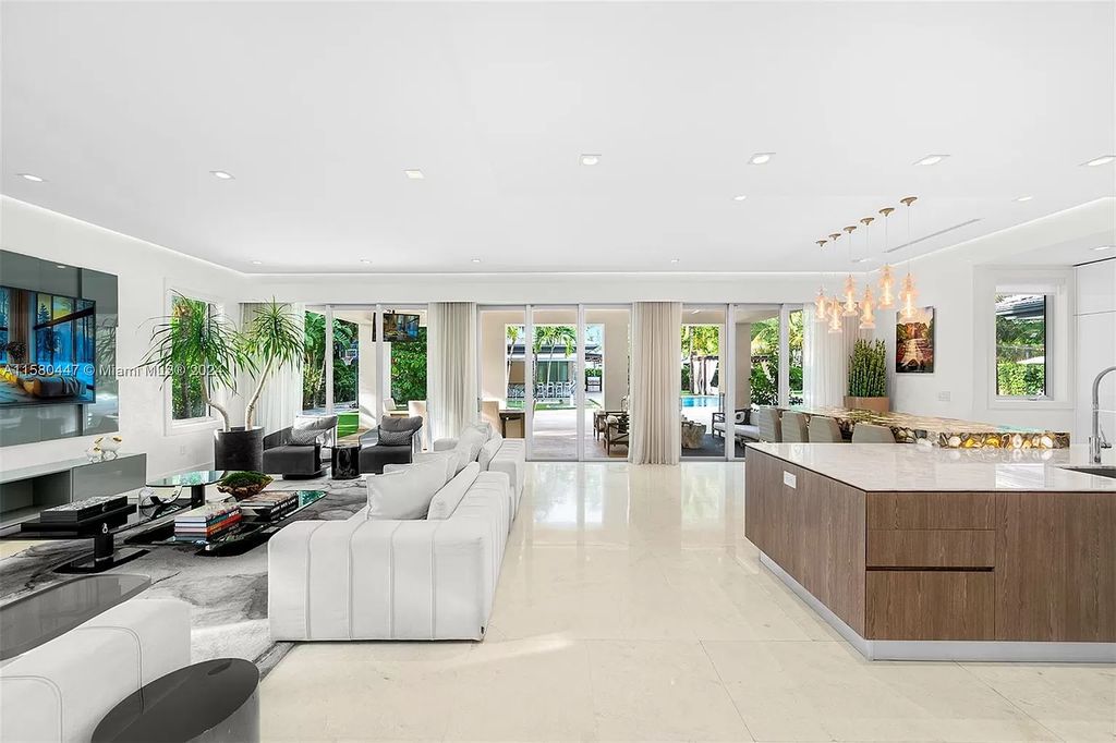 Enter a world of luxury in this exquisite 2-story gated sanctuary. Boasting a grand foyer, chef's kitchen, 4-suite bedrooms, elevator, home theater, and tropical backyard oasis with a guest house, this home offers unparalleled living.