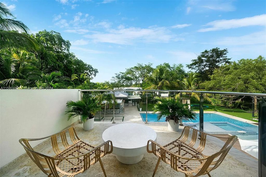 Enter a world of luxury in this exquisite 2-story gated sanctuary. Boasting a grand foyer, chef's kitchen, 4-suite bedrooms, elevator, home theater, and tropical backyard oasis with a guest house, this home offers unparalleled living.