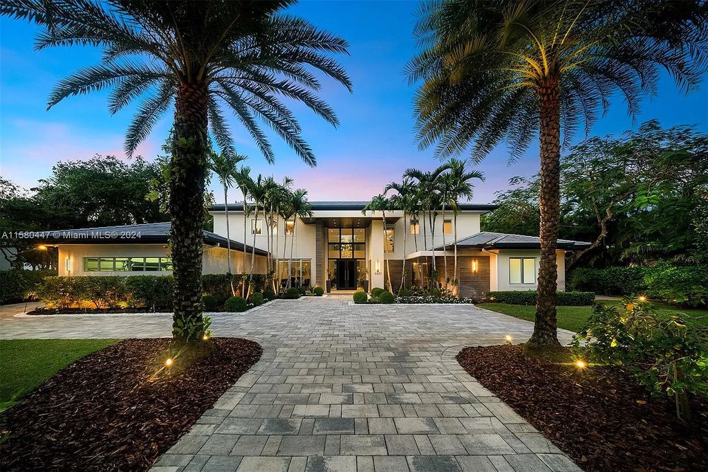 Enter a world of luxury in this exquisite 2-story gated sanctuary. Boasting a grand foyer, chef's kitchen, 4-suite bedrooms, elevator, home theater, and tropical backyard oasis with a guest house, this home offers unparalleled living.